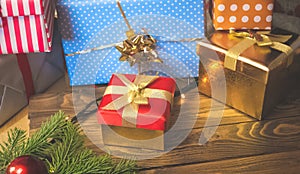 Closeup image of colorful Christmas gift boxes and present on wooden background