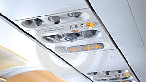 Closeup image of control panel with emergency signs and air conditioner system in modern airplane