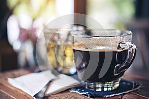 Closeup image of cups of hot coffee and tea on vintage wooden table