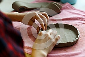 Closeup Image of Female Hands Works with Clay Makes Future Ceramic Plate, Classes of Hand Building in Modern Pottery