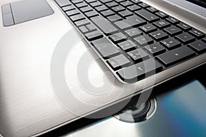 Closeup image of a laptop and CD