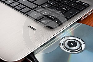 Closeup image of a laptop and CD