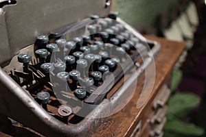 A closeup image of an old vintage type writer with eroded keys with selective focus on A S D W keys and background blur