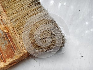Closeup image of a paint brush on the floor
