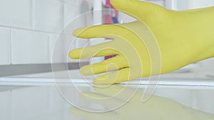 Closeup Image with a Person Hands Wearing Protective Yellow Household Gloves Used in the Kitchen Cleanse