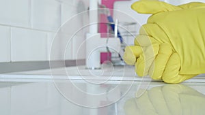 Closeup Image with a Person Hands Wearing Protective Yellow Household Gloves Used in the Kitchen Cleanse