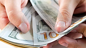 Closeup image of rich man counting big stack of money