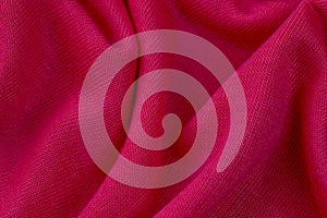 Closeup image of a soft, pink fabric texture with subtle details of the weave visible photo