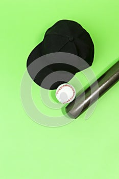 Closeup Image of Stylish Laquered Wooden Brown American Baseball Bat Placed With Clean Leather White Ball and Black Cap Over