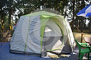 Closeup image of a tent in between a forest