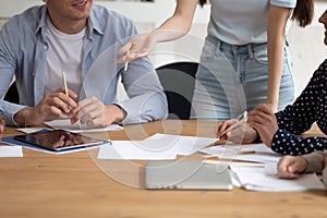 Closeup image unrecognizable group of students do common task indoors