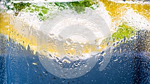 Closeup photo of water droplets on misted glass of cold lemonade