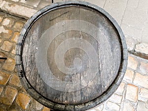 Closeup image of wet wooden lid on old barrel after rain