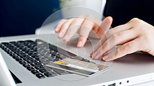 Closeup image of woman doing online shopping and using credit card