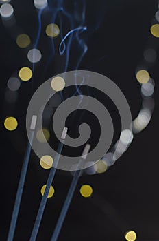 Closeup of incenses against of bokeh lights.Concept of meditaion and tranquility photo