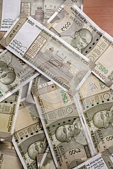 A closeup of Indian 500 rupee bills in a heap - Texture of a pile of Indian money