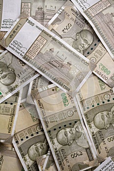 A closeup of Indian 500 rupee bills in a heap - Texture of a pile of Indian money
