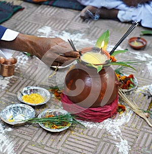 Closeup of Indian groom father offering prayer during marriage.