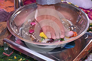 Closeup of Indian groom`s foot while a traditional ritual performed during the wedding