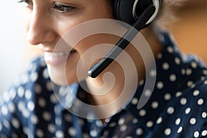 Closeup indian woman helpline employee wear headset talk to client
