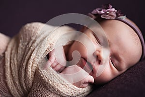 Closeup infant baby girl sleeping at background. Newborn and mothercare concept