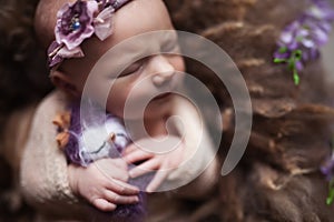 Closeup Infant baby girl sleeping at background. Newborn and mothercare concept