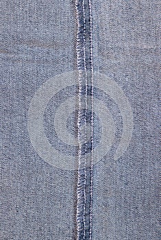 Closeup of the inner side of a gray denim fabric with the overstitch