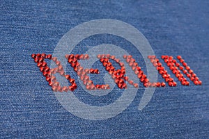 Closeup inscription Berlin, inlaid rhinestones on denim.