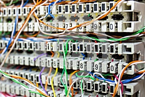 Closeup Inside a PBX telephone booth that has a number of connecting cables in many colors