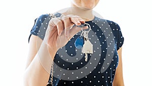 Closeup isolated photo of young real estate agent showing keys from new house