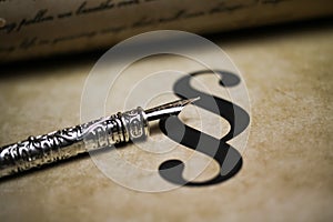 Closeup of isolated paragraph sign on ol vintage paper with silver retro ink pen and text document