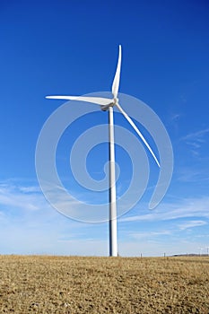 A closeup isolated vertical photo of Wind turbines in Alberta, Canada. Renewable energy concept.