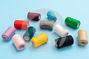 Closeup isometric view of scattered colored spools of sewing threads