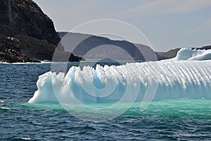 Closeup of jagged iceberg marooned along the coastline photo