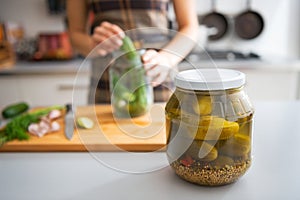 Closeup on jar of marinated cucumbers on table