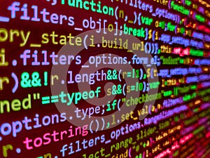 Closeup of Java Script and HTML code. Computer script coding source code on desktop monitor. Software engineer at work. Programmer