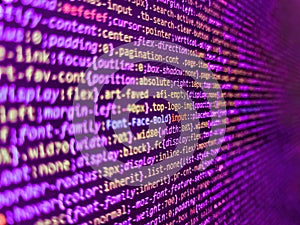 Closeup of Java Script and HTML code. Programmer working on computer screen. Lines of code of a software with several colors.