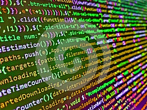Closeup of Java Script and HTML code. Programming text on dark screen. Big data storage and cloud computing representation.