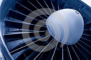 Closeup jet engine blades of airplane. Blue color tone