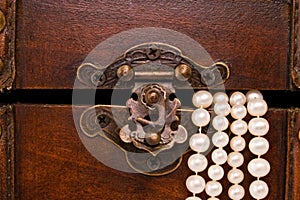 Closeup jewellery box latch and pearls