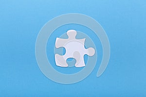 Closeup of jigsaw puzzle on blue background Missing jigsaw puzzle piece, business concept for completing the piece