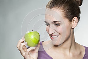 Closeup on joyful gorgeous 20s girl resisting in symbol of fresh fruit and diet