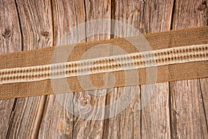 Closeup of a jute natural sackcloth strip on a wooden surface