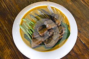 Closeup of Kare Kare with Lechon Kawali. A Filipino fusion dish
