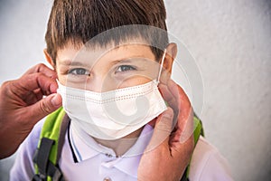 Closeup Kid face wearing protective face mask for pollution or virus, Cropped shot of school boy wearing protection mask against