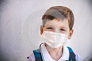 Closeup Kid face wearing protective face mask for pollution or virus, Cropped shot of school boy wearing protection mask against