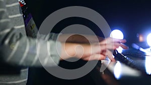 Closeup kid`s hand playing piano on stage, favorite classical music, hands of professional girl playing piano