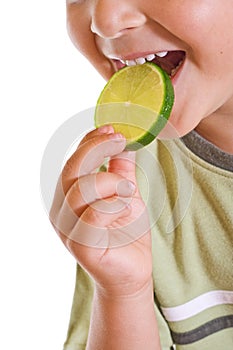 Closeup of kid with a slice of lime