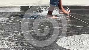 Closeup kids feet walking and splashing in fountain