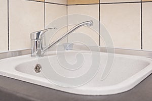 Closeup of Kitchen Marble Sink and Installed New Faucet.